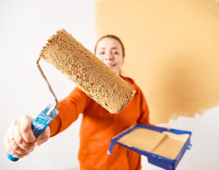 Smiling caucasian woman painting interior wall of home. Renovation apartment. repair and redecoration concept. copy space Smiling caucasian woman painting interior wall of home. Renovation apartment. repair and redecoration concept. copy space
